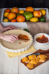 Obraz na płótnie Canvas production of cake with citrus marmalade and slices of mandarin