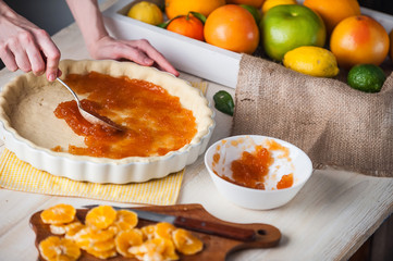 production of cake with citrus marmalade and slices of mandarin