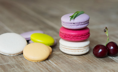 Set of colorful macaroon dessert on wooden tabletop.