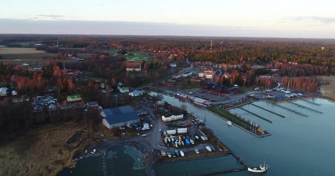 Cinema 4k aerial orbit flight of Inkoo town, at a late evening sunset, in the finnish archipelago, in Finland