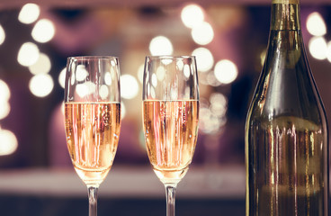 Time to party and celebrate! Pair of champagne glasses in a restaurant setting. 