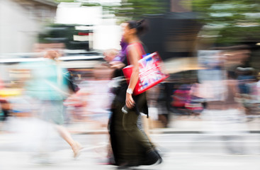 Lots of people walking in Oxford street, London. Blurred image. 