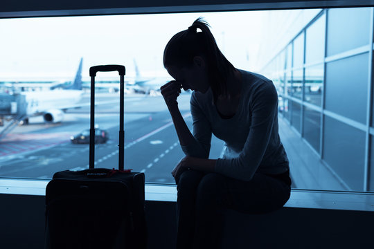Sad woman sitting in airport. 