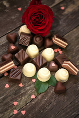 Sweet chocolate pralines and red roses.