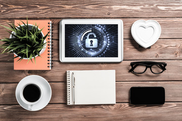 Naklejka premium Web security and technology concept with tablet pc on wooden tab