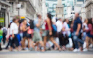 Regent street with lots of walking people crossing the road. Blurred image for background