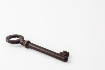 Antique rusty key isolated on white background