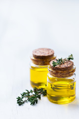 Organic essential thyme oil with green leaves