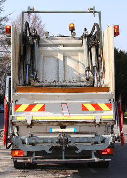 Garbage Trucks During The Solid Waste Collection Service In The