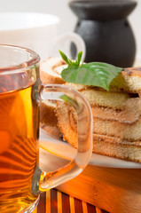 Big mug of tea and chocolate cake on a table