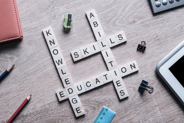 Conceptual business keywords on table with elements of game making crossword
