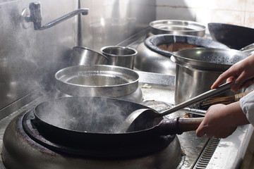 Close up of working chef preparing chinese food