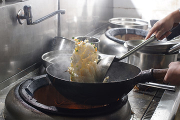 Close up of working chef preparing chinese food