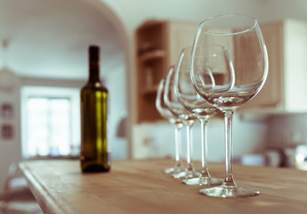 Row of wine glasses on a bar. 