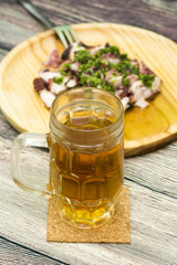 Octopus with paprika and beer, typical dish of Spain, on a woode