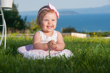 Sweet baby girl playing outdoors. Baptism, Wedding & Fashion