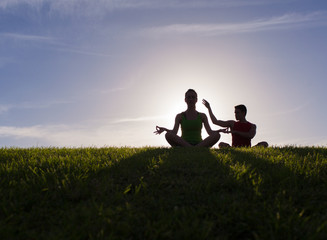 Naklejka na ściany i meble Yoga and meditation. Young couple relax the mind body a spirit.