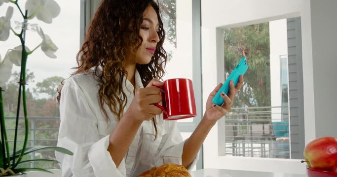 Woman starting her day with a coffee at home