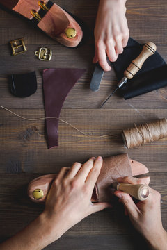 cobbler tools in workshop dark background top view