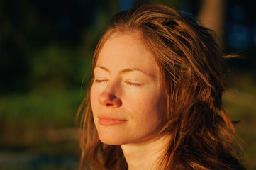 Young woman happy with eyes closed