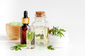 organic cosmetics with extracts of herbs rosemary on white background