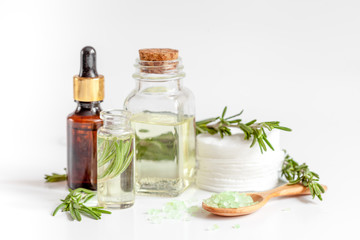 organic cosmetics with extracts of herbs rosemary on white background