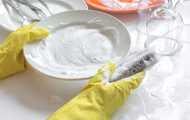 concept of woman washing dishes on white background
