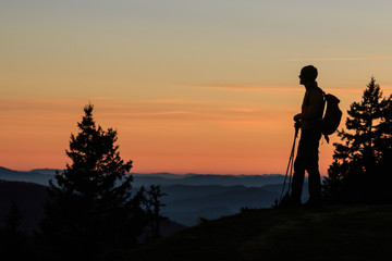 Mountaineer silhouette at the sunset on the Kosuta ridge in Karavanke range, Slovenia