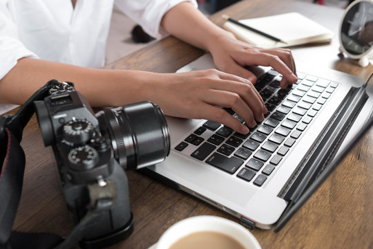 Photographer editing photos on laptop. Studio work, photo service concept. Workplace