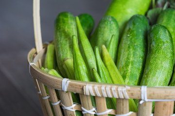 Tropical green organic vegetable on basket on wooden background