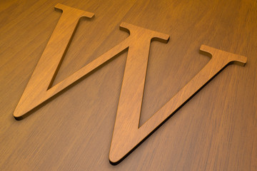 Wooden letter W on wood background, 3d illustration