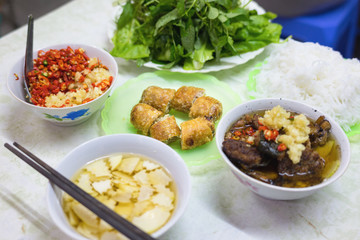 "Bun cha", a Vietnamese famous noodle soup of grilled pork and rice noodles served with fresh herbs, dipping sauce and spring roll