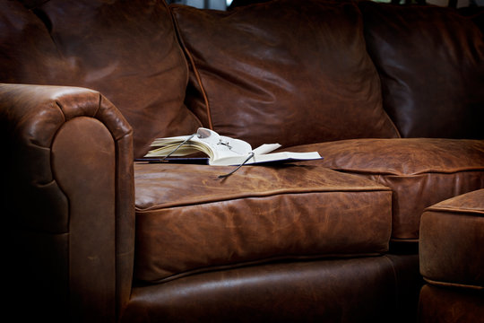 Cozy Reading Spot On A Soft Brown Leather Sofa