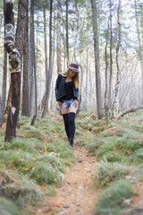 Obraz premium Beautiful young girl walking in the autumn forest.