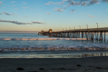 Imperial Beach fishing pier at dawn with beach in foreground in San Diego, California.