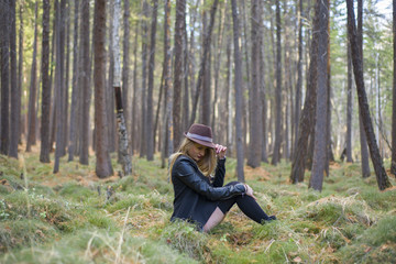 Fototapeta premium Beautiful young girl walking in the autumn forest.