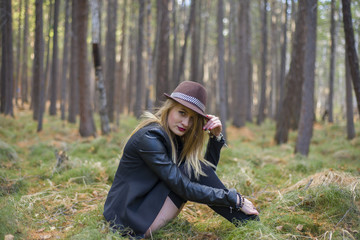 Beautiful young girl walking in the autumn forest.