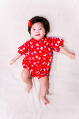 baby girl with cute red Japanese style outfit and white background