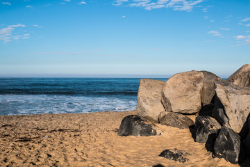 Boulders on sandy beach in Imperial Beach, California.