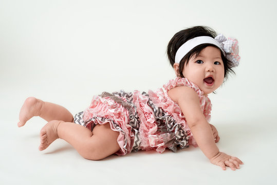 Baby Girl With Cute Floral Dress And White Background