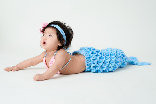 baby girl with cute mermaid outfit and white background