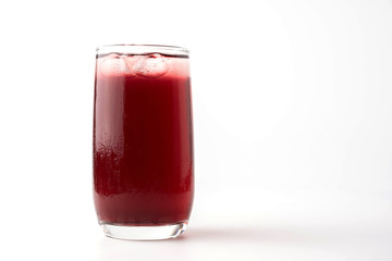 Glass of pomegranate juice with fruit isolated on white.