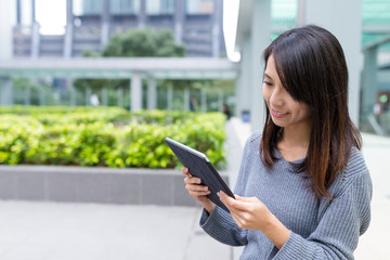 Fototapeta premium Woman looking at digital tablet at outdoor