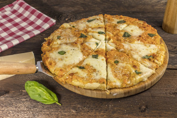 Homemade Margherita pizza on dark wooden table