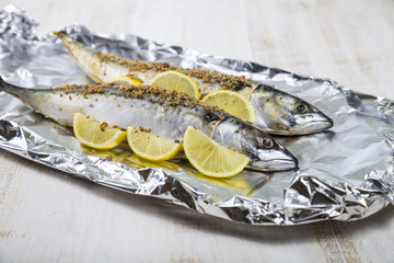 Raw mackerel in foil close up. Preparation of fresh fish.