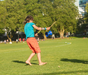 Fototapeta premium outdoor portrait of young boy playing with diabolo, chinese yo-y