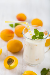 Smoothie or yogurt with blueberries on a wooden table. Delicious