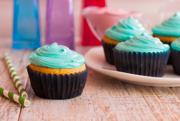 Mint cupcakes on the wooden background