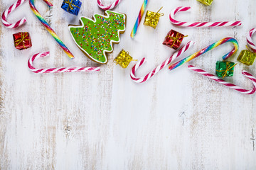 Gingerbread and candy canes on a  wooden background. Christmas s