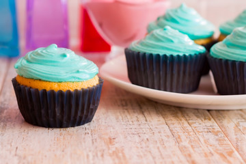 Mint cupcakes on the wooden background